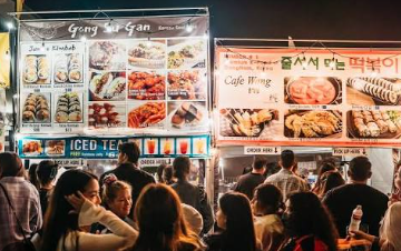 Korean street food stalls at night with crowds of visitors at Goseokjeong festival, Cheorwon